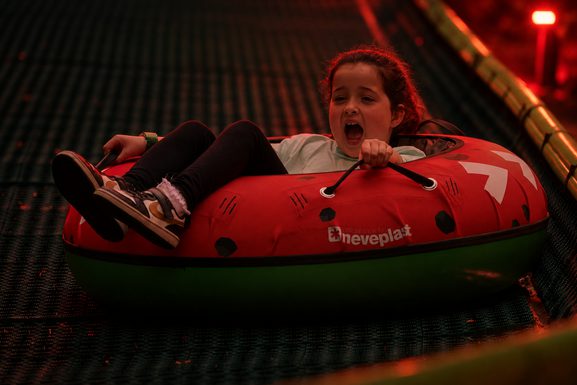 Red Lit Nighttime Snow Tube Ride 1