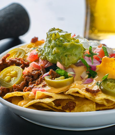 Plate of loaded nachos with queso cheese 2026 01 09 08 10 41 utc